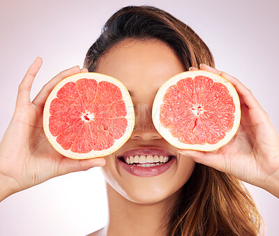Buy stock photo Beauty, grapefruit and eyes of woman with healthy, natural or organic care isolated in a brown studio background. Citrus, happy and young female person with vitamin c for skincare, wellness or detox