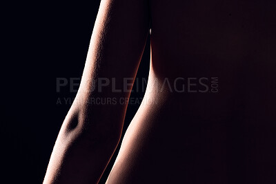Buy stock photo Beauty, body and person on black background for creative lighting, shadow and silhouette. Aesthetic, skincare and closeup of waist in dark studio with macro of skin for art deco, wellness and glow