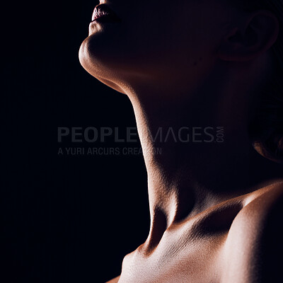 Buy stock photo Skincare, neck and person on black background for creative lighting, shadow and silhouette. Aesthetic, beauty and closeup of body in dark studio with macro of skin for art deco, wellness and glow
