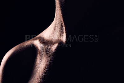 Buy stock photo Beauty, neck and person on black background for creative lighting, shadow and silhouette. Aesthetic, fantasy and closeup of body in dark studio with macro of skin for art deco, wellness and glow