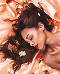 Hair, silk and flowers by a woman with beauty and cosmetic fashion fabric for wellness, glow and skincare. Aesthetic, plants and calm young female person with luxury elegant backdrop in spring