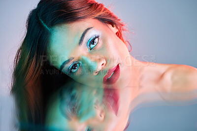 Buy stock photo Art, reflection and beauty, portrait of woman on studio background with neon light and makeup. Fashion, skin and aesthetic, face of girl, model in creative mirror pose with cosmetics and 