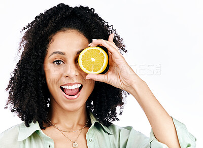 Buy stock photo Vitamin c, lemon and eye or portrait of woman with fashion for organic wellness isolated in a studio white background. Diet, fruit and happy or excited young person with crazy citrus energy and detox