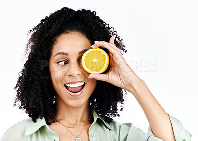 Buy stock photo Citrus, lemon and eye of woman with fashion for organic wellness isolated in a studio white background. Diet, fruit and happy or excited young person with crazy vitamin c energy, health and detox