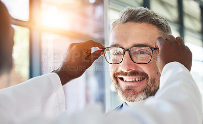 Buy stock photo Optometry, doctor and glasses for happy man at a clinic for vision, healthcare and help with eye care. Smile, retail and a male customer with an optometrist and eyewear during a medical consultation