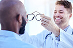 Glasses, optometrist and patient with men in clinic, vision and prescription lens with frame, choice and test. Eyesight, eye care and optometry, health and male people with decision for spectacles