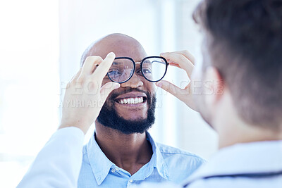 Buy stock photo Smile, African man and optometrist with glasses for eye support and lens check at a doctor consultation. Medical, wellness and patient with vision and eyewear care with professional holding frame