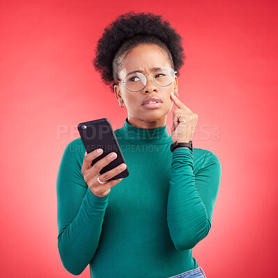 Buy stock photo Thinking, phone and black woman in studio confused by text, application or how to steps on red background. Doubt, why and African person with questions for scam or spam contact on smartphone 