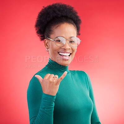 Buy stock photo Portrait, excited and black woman with call me hand in studio isolated on a red background with glasses. Face, happy and African person with shaka gesture, emoji sign and phone for communication 