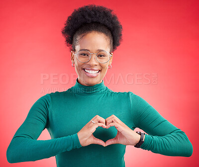 Buy stock photo Happy woman, portrait and heart hands for love, care or romance against a red studio background. Female person smile with emoji, symbol or shape for romantic gesture, health support or like on mockup