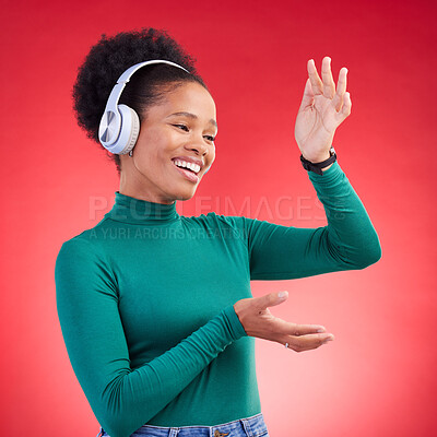 Buy stock photo Happy, dance and black woman with music headphones in studio, freedom and good mood on red background. Podcast, radio and African female with earphone streaming, dancing and celebrating vibes 
