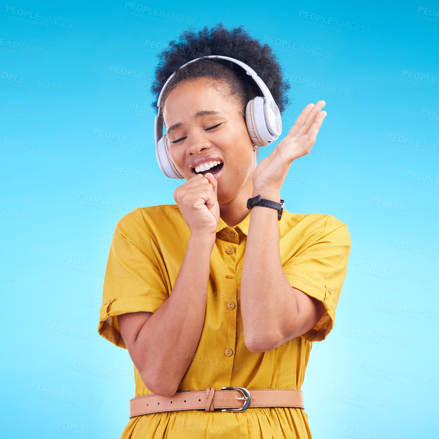 Buy stock photo Happy woman, headphones and singing while listening to music for karaoke against a blue studio background. Female person enjoying audio sound track or song with headset for entertainment on mockup