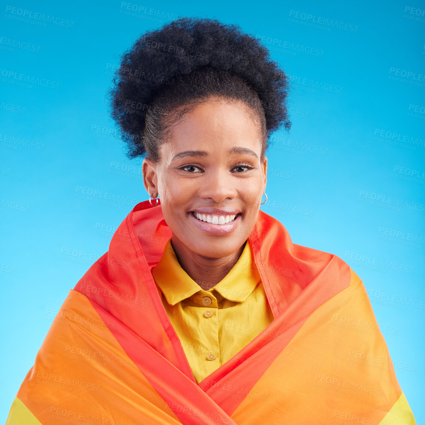 Buy stock photo Pride, flag and portrait of black woman in studio for gay, rights and lgbtq lifestyle on blue background. Rainbow, freedom and face of lesbian African female happy, smile and confident with sexuality