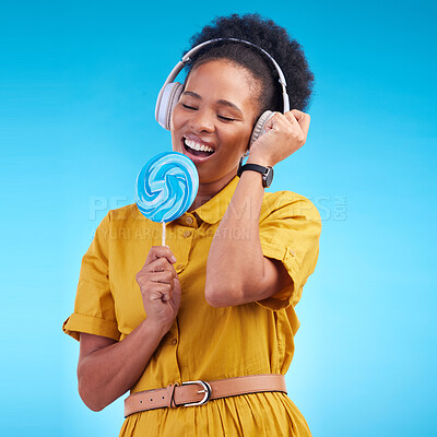 Buy stock photo Music, singer and lollipop with black woman and headphones for streaming, audio and media. Radio, technology and freedom with female person on blue background for listening, sound and podcast