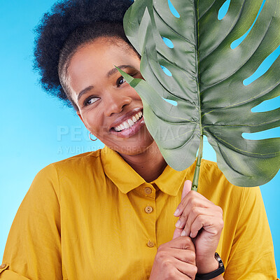 Buy stock photo Fashion, happy and black woman with plant on blue background for cosmetics, makeup and beauty. Nature, studio and female person with monstera leaf for organic, natural and detox products for wellness