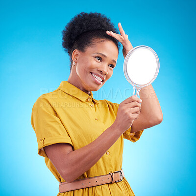 Buy stock photo Happy, beauty and a woman with a mirror in studio for hair care, confidence and appearance. Fashion, makeup and cosmetics of African female model person in casual style clothes on a blue background