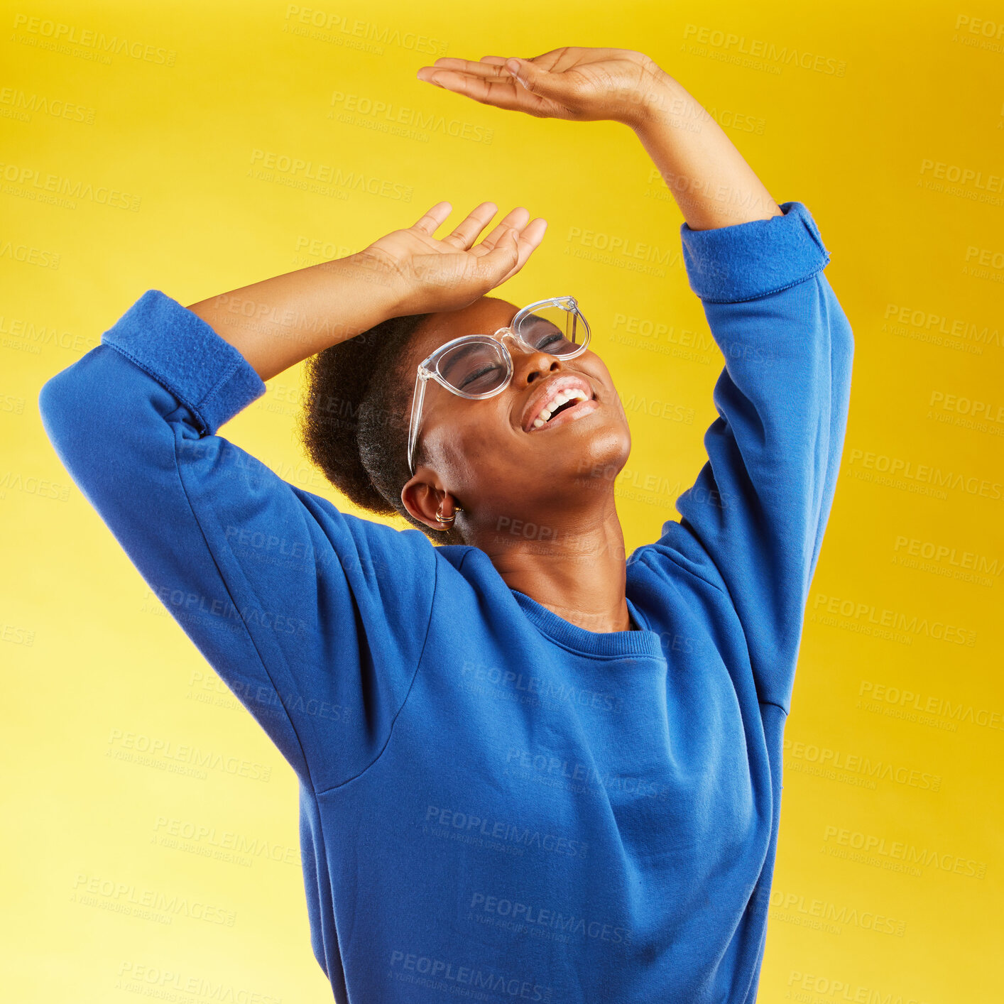 Buy stock photo Fashion, freedom and fun with a black woman on a yellow background in studio for trendy gen z style. Relax, smile and excited with a happy young girl indoor to dance with a carefree expression