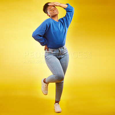 Buy stock photo Fashion, faint and young black woman in casual jeans for style or clothing isolated in a studio yellow background. Sad, tired and African person with natural beauty, confident and posing with drama
