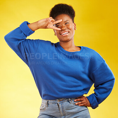 Buy stock photo Hand sign, peace and a black woman in studio with a smile, confidence and a positive mindset. Emoji, icon and happy african female model person on yellow background with a v symbol and freedom