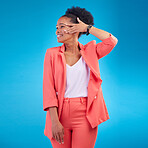Fashion, smile and confident with a black woman on blue background in studio posing in a suit for style. Face, clothes and a happy young female model standing in a trendy outfit for a magazine cover