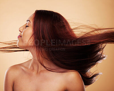 Buy stock photo Woman, shake hair and beauty with texture, cosmetics and grooming against a brown studio background. Female person, wind and model with shine, natural treatment or aesthetic with confidence or luxury