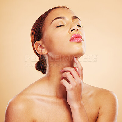 Buy stock photo Beauty, skincare touch and woman with eyes closed in studio isolated on brown background. Face, makeup cosmetics and natural model touch neck after spa facial treatment for wellness and healthy skin