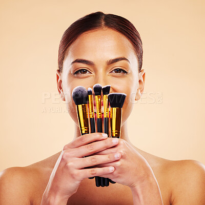 Buy stock photo Makeup, brush and portrait of woman with cosmetic beauty product for skincare isolated in a studio brown background. Happy, elegant and powder for cosmetology aesthetic, glow and soft skin glamour