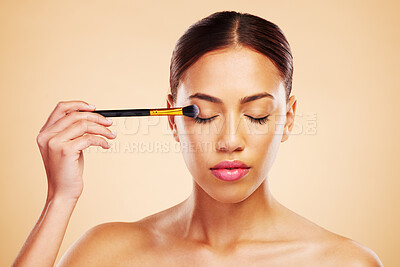 Buy stock photo Makeup, brush and woman with cosmetic beauty product application for skincare isolated in a studio brown background. Eyelid, elegant and powder for cosmetology aesthetic, glow and soft skin glamour