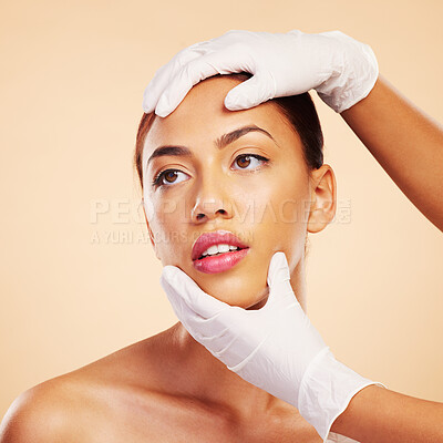 Buy stock photo Hands, plastic surgery or facelift for woman in studio ready for laser, filler implant or beauty transformation. Skincare consultation, facial or gloves for change or liposuction on brown background