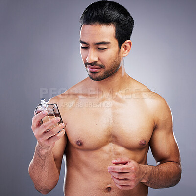 Buy stock photo Topless, cosmetics or man with cologne for beauty or self care isolated on studio background. Wellness, male person or Asian model with luxury body perfume spray with fragrance bottle or grooming