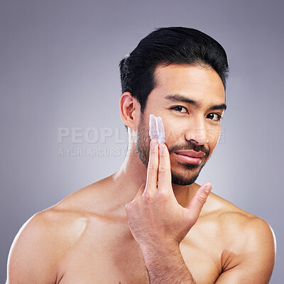 Buy stock photo Skincare portrait, cream and studio man with facial cleaning routine, morning hydration or spa self care. Bathroom cosmetics, face lotion product and aesthetic person wellness on gray background