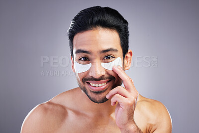 Buy stock photo Portrait, skincare or happy man with eye patch for beauty or wellness isolated on studio background. Cosmetics, smile or model with facial collagen pads or dermatology product for anti aging or glow