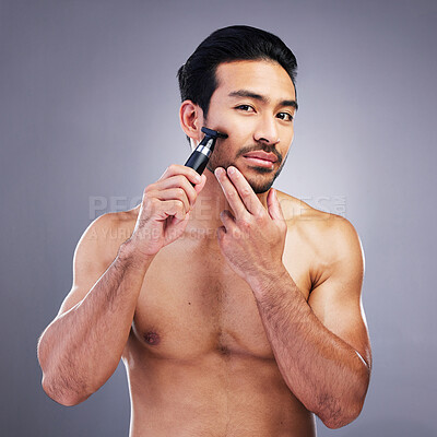 Buy stock photo Beard hair, trimmer and portrait of man with bathroom routine, wellness grooming and cosmetics skincare. Morning face cleaning, facial growth maintenance and studio person shaving on grey background