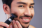 Beard hair trimmer, happiness and man portrait for bathroom shaving, blade grooming or morning beauty routine. Studio razor, facial cleaning and closeup person with fresh face glow on gray background