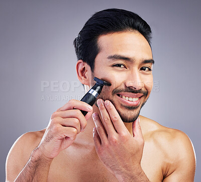 Buy stock photo Beard hair trimmer, portrait and man smile for bathroom shaving routine, grooming or morning skincare. Studio razor, facial growth maintenance and Mexican person with clean face on gray background