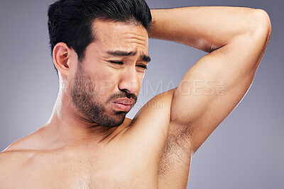Buy stock photo Armpit, smell and man with body odor in studio isolated on a white background for deodorant, cleaning and skincare cosmetic. Underarm, bad stink and model with hyperhidrosis, sweating or poor hygiene