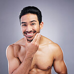 Portrait, skincare and man with facial, cosmetics and natural beauty against a grey studio background. Face, male person and model with grooming routine, muscle and luxury with wellness and aesthetic