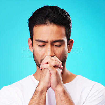 Buy stock photo Praying, hands and man in meditation or worship to God for faith or belief in spirituality, mindfulness and peace in studio. Christian, prayer and person with religion and zen on blue background