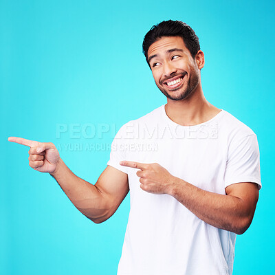 Buy stock photo Mockup, pointing and man with a smile, thinking and choice against a blue studio background. Male person, decision or model with product placement, hand gesture and presentation with sign and showing