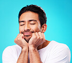 Sleeping, dreaming and man face in studio with memory, relax smile and thinking to remember. Isolated, blue background and happy Indian male model with eyes closed for rest and nap feeling thoughtful