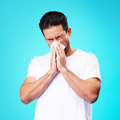 Buy stock photo Tissue, nose and man in studio for sick allergy, cold and influenza on blue background. Asian male model sneeze wit hayfever, allergies and infection of virus bacteria, health care and congestion