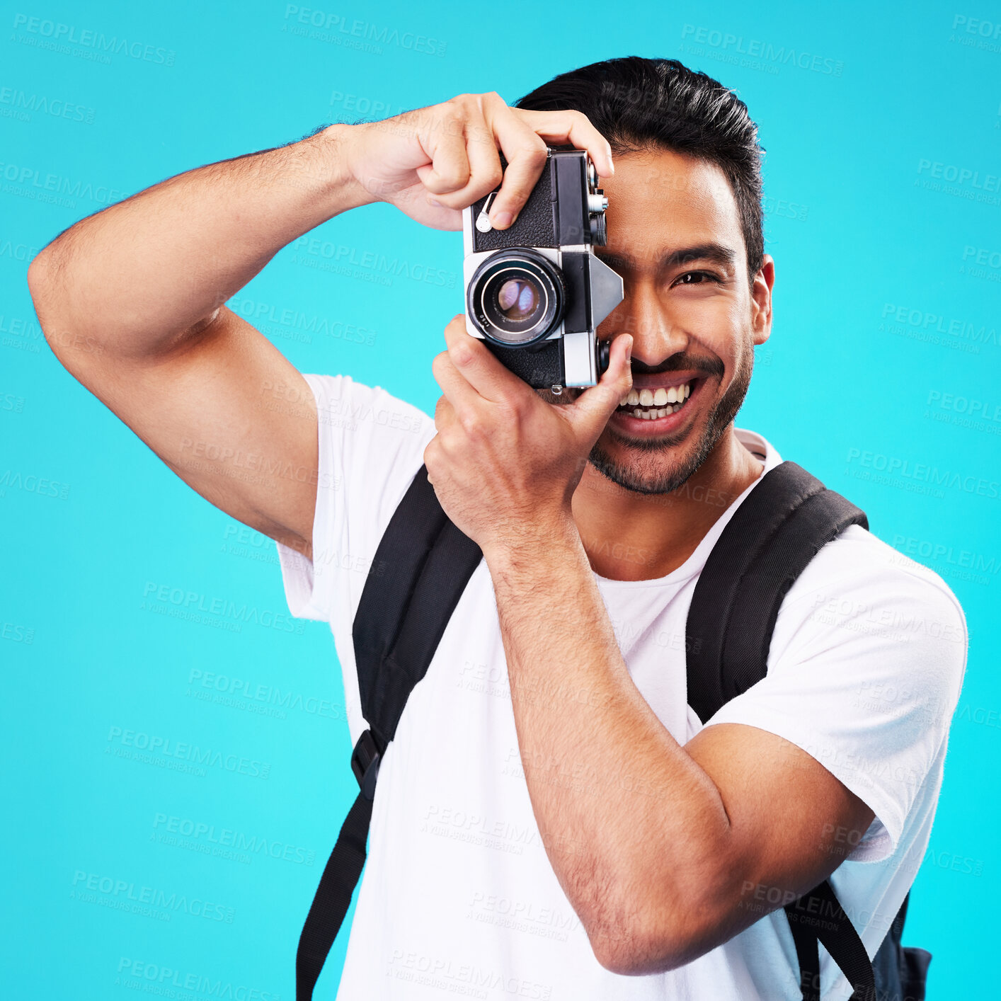 Buy stock photo Portrait, smile and man with a camera, photography and taking picture against a blue studio background. Face, male person or model with creativity, vintage technology or photographer with inspiration