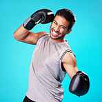 Boxer man, punch and studio portrait with sweat, workout and training for fitness by blue background. Guy, boxing gloves and power for exercise, fight and development for performance in combat sports