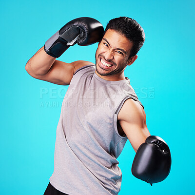Buy stock photo Boxer man, punch and studio portrait with sweat, workout and training for fitness by blue background. Guy, boxing gloves and power for exercise, fight and development for performance in combat sports