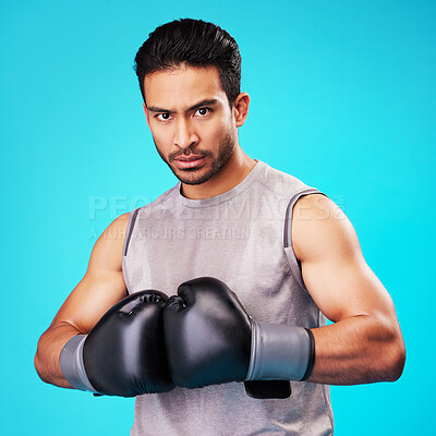 Buy stock photo Portrait, man and fighter training, boxing or challenge on a blue studio background. Male person, Asian boxer or athlete with power, strong or serious face with workout, fight or wellness with sports