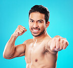 Man, shirtless and martial arts in studio portrait with power, punch and anger by blue background. Guy, mma and muscle for fight, contest or sport with exercise, training and workout for competition