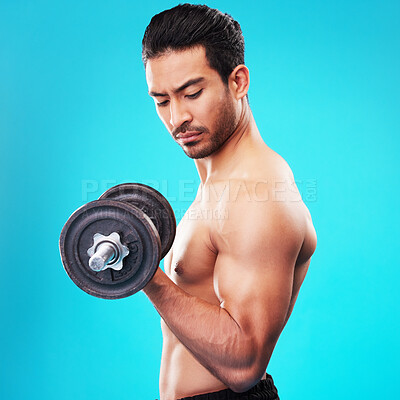 Buy stock photo Weightlifting, fitness and man with dumbbell training, exercise or workout isolated in a studio blue background. Bodybuilder, wellness and healthy young person doing body or bicep strength endurance