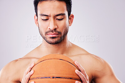 Buy stock photo Fitness, basketball and a shirtless sports man in studio on a gray background for training or a game. Exercise, workout or mindset and a young male athlete holding a ball with focus or confidence