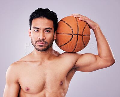 Buy stock photo Portrait, basketball and body with a sports man in studio on a gray background for training or a game. Fitness, muscle or mindset and a shirtless young male athlete holding a ball with focus