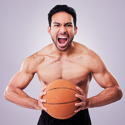 Buy stock photo Portrait, basketball and a sports man shouting in studio on a gray background for training or a game. Fitness, body and aggression with a young male athlete holding a ball while screaming in anger